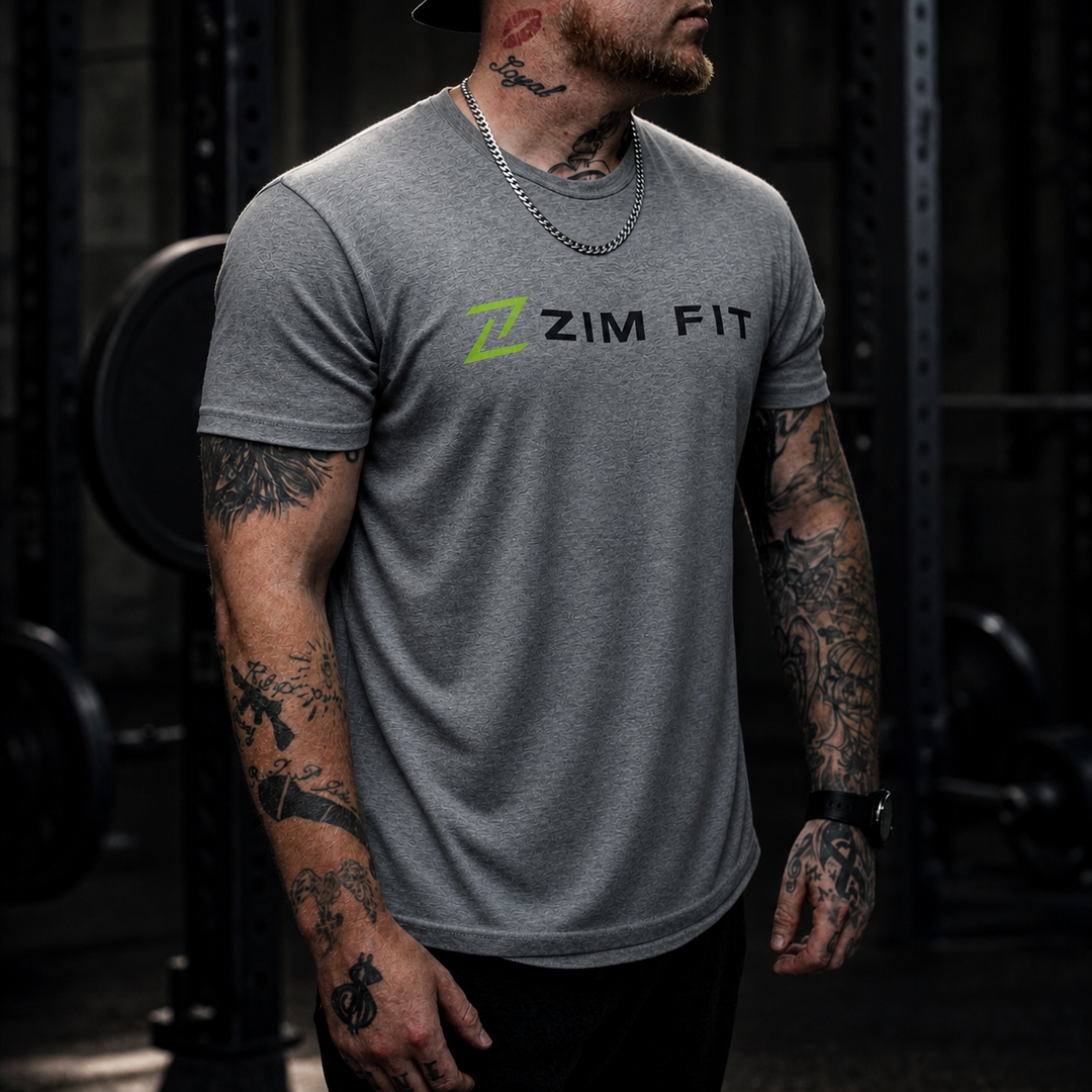 A man wearing a heather gray t-shirt with a green and black &